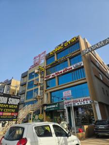 a building with cars parked in front of it at hotel vistara luxe in Himatnagar