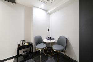 a room with two chairs and a small table at Hip Hotel in Seoul