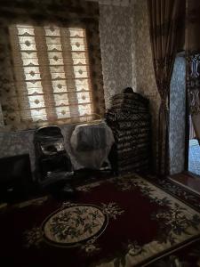 a living room with a couch and a window at Kyzilnavr in Baysun