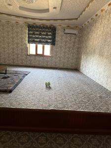 an empty room with a dance floor and a window at Kyzilnavr in Baysun