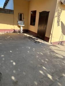 a building with a door and a chair in front of it at Kyzilnavr in Baysun