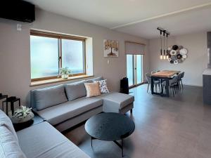 a living room with a couch and a table at KUON Onomichi - クオン尾道 in Onomichi