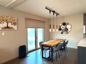 a dining room with a table and chairs at KUON Onomichi - クオン尾道 in Onomichi