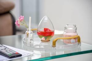 a glass vase with a fruit in it on a table at The Premier Comfort in Nairobi