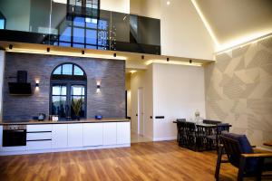 an open kitchen with white cabinets and a dining room at Arinest Villa with heated pool, 20 min from Yerevan in Elar