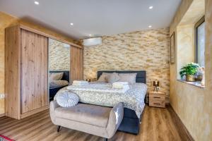a bedroom with a bed and a chair at Vila Leonarda with Terrace and Garden - Happy Rentals in Miren +27 photos