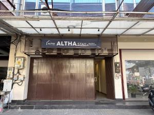 an entrance to a building with a sign on it at Altha Stay Cokro in Ngabean