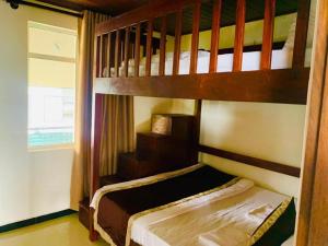 a bedroom with two bunk beds and a window at Lake Infinity Luxury Condos in Nuwara Eliya