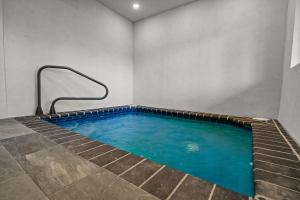 a lap pool in a room with blue water at Cedar Splash in Sevierville