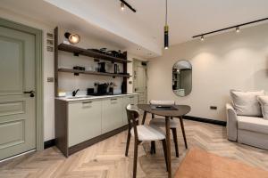 a kitchen and dining room with a table and a couch at GuestReady - The Euston in London