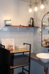 a bathroom with a table with a sink and a mirror at Charlotte place in El Nido