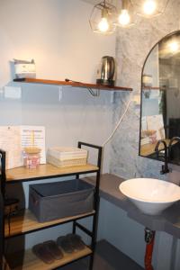 a bathroom with a sink and a mirror at Charlotte place in El Nido +8 photos