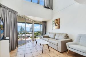 a living room with a couch and a table at Alex Beach Resort 3BR Apt 428 in Alexandra Headland