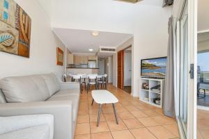 a living room with a couch and a table at Alex Beach Resort 3BR Apt 428 in Alexandra Headland +10 photos