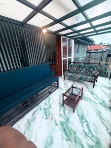 a living room with two benches and a balcony at Padmora in Trivandrum