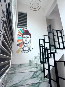 a mural on a wall in a room with stairs at Padmora in Trivandrum