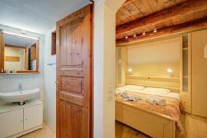 a bathroom with a bed and a sink in a room at La Capannina Lake & Mountain Views - Happy Rentals in Cimo