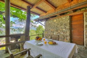a table with two bowls of fruit on a porch at La Capannina Lake & Mountain Views - Happy Rentals in Cimo +29 photos