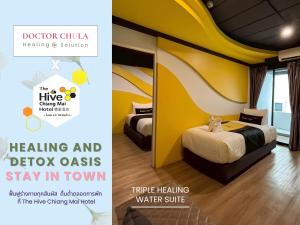 a hotel room with a bed and a yellow wall at The Hive Chiang Mai Hotel in Chiang Mai