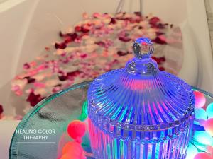 a blue glass container sitting on a table with a mirror at The Hive Chiang Mai Hotel in Chiang Mai