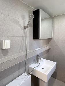 a bathroom with a sink and a shower at 303 Stayonyou Gocheok Dome Hongdae Subway 3Min in Gwangmyeong