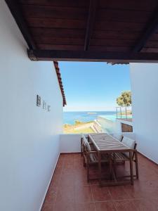 a table and chairs on a balcony with a view of the ocean at Summer Palace Evia in Petriaí