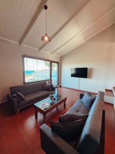 a living room with two couches and a coffee table at Summer Palace Evia in Petriaí