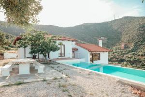 a villa with a swimming pool and a house at Summer Palace Evia in Petriaí