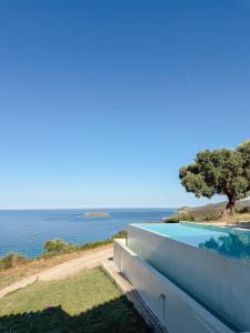 a swimming pool with a view of the ocean at Summer Palace Evia in Petriaí