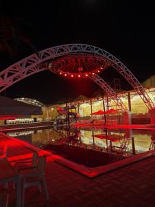 a carnival ride with red lights and a bridge at Turon plaza hotel in Bukhara