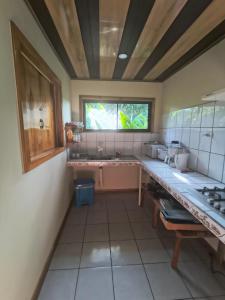 a large kitchen with a counter and a window at Drake Bay Corcovado The Monkey Trail in Drake +44 photos