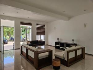 a living room with a couch and a table at Sunrise Staycation in Katuneriya