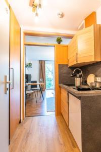 a kitchen with a door open to a dining room at Black Mirror inkl WLAN, Parkplatz Krankenhaus Detmold in Detmold