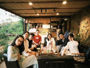 a group of people sitting in a rv at Đồi Ông Thoại Cottage in Bảo Lộc