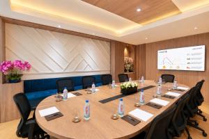 a conference room with a large wooden table and chairs at Harmony Phnom Penh Hotel in Phnom Penh +72 photos