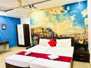 a bedroom with a large bed with a painting on the wall at IR Luxuria Hotel, Guwahati in Guwahati