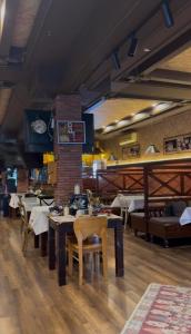 a dining room with tables and chairs in a restaurant at Antika Hotel in Batumi