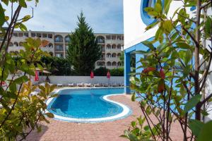 a swimming pool in front of a hotel at Hotel Nadia in Primorsko