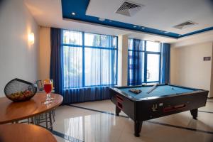 a living room with a pool table and a tableablish at Hotel Nadia in Primorsko