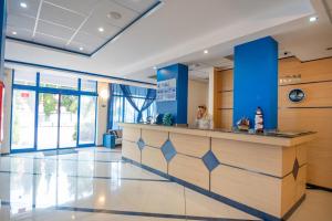 a woman standing at a counter in a lobby at Hotel Nadia in Primorsko +29 photos