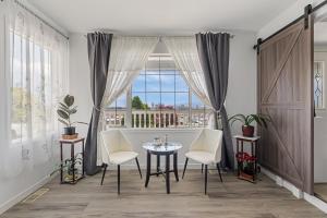 a dining room with a table and chairs and a window at KnoxPeace BnB in Kelowna