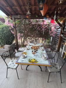 a table on a patio with dishes on it at Villa Aghjanella in Patrimonio