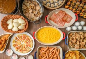 a table topped with bowls of different types of food at Hotel Monterey Le Frere Osaka in Osaka