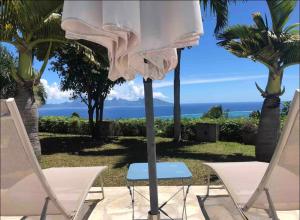 two chairs and a table with a towel on top at Suite confortable avec vue imprenable in Punaauia +8 photos