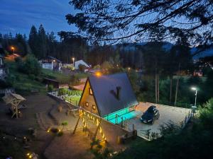 a small building with a roof in a parking lot at Vikendica Villa Marija Pale in Pale