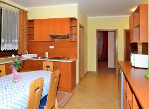 a kitchen with a table and a dining room at Apartmany Broma in Liptovský Mikuláš