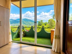 a room with a large window with a view at Polo Region Rest Inn in Haputale
