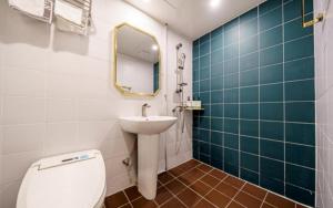 a bathroom with a sink and a toilet and a mirror at 넘버25 신촌점 in Seoul +32 photos