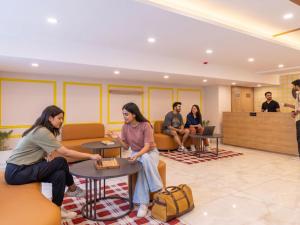 a group of people sitting in a waiting room at The Hosteller Gurgaon in Gurgaon +6 photos