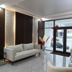 a living room with a white couch and a window at TUMAR hotel in Zhezdi